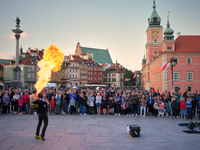 A street performer is seen spitting fire and flames in Warsaw, Poland on 12 October, 2024. (