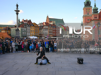 A street performer busker is seen juggling knives in the Old Town in Warsaw, Poland on 12 October, 2024. (