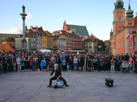 A street performer busker is seen juggling knives in the Old Town in Warsaw, Poland on 12 October, 2024. (