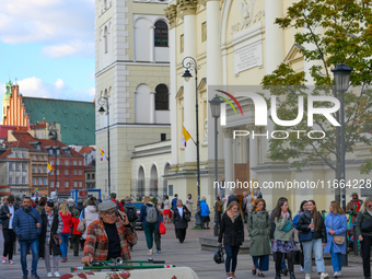 A man on a cargo bike is seen in the Old Town in Warsaw, Poland on 12 October, 2024. (