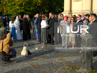 Members of a wedding party are seen having their picture taken in Warsaw, Poland on 12 October, 2024. (