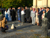 Members of a wedding party are seen having their picture taken in Warsaw, Poland on 12 October, 2024. (