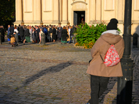 A man looks on as people gather outside a church after a wedding ceremony in Warsaw, Poland on 12 October, 2024. (