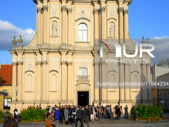 Pepole are seen during a wedding in front of a church in Warsaw, Poland on 12 October, 2024. (