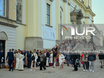 Pepole are seen during a wedding in front of a church in Warsaw, Poland on 12 October, 2024. (