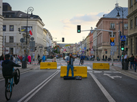 A busker playing a violin on a street closed for traffic is seen in Warsaw, Poland on 12 October, 2024. (