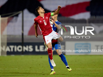 Matthew Guillaumier of Malta competes for the ball with Andrei Motoc of Moldova during the UEFA Nations League, League D, Group D2 soccer ma...