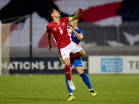 Matthew Guillaumier of Malta competes for the ball with Andrei Motoc of Moldova during the UEFA Nations League, League D, Group D2 soccer ma...