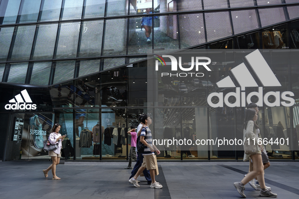 People walk past a shopping mall and the popular Siam Square shopping area in Bangkok, Thailand, on October 14, 2024. 