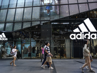 People walk past a shopping mall and the popular Siam Square shopping area in Bangkok, Thailand, on October 14, 2024. (