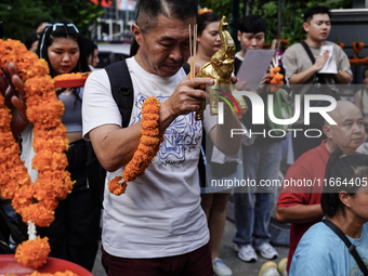 Thais and foreign tourists worship a statue of Lord Brahma, the Hindu god of creation, for good fortune at the Erawan Shrine in Bangkok, Tha...