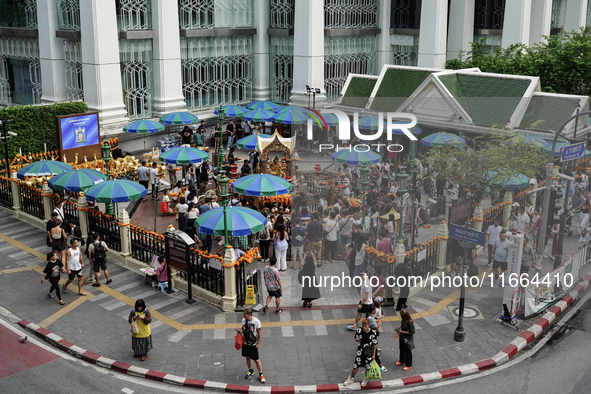 Thais and foreign tourists worship a statue of Lord Brahma, the Hindu god of creation, for good fortune at the Erawan Shrine in Bangkok, Tha...