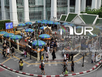 Thais and foreign tourists worship a statue of Lord Brahma, the Hindu god of creation, for good fortune at the Erawan Shrine in Bangkok, Tha...