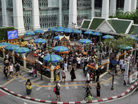 Thais and foreign tourists worship a statue of Lord Brahma, the Hindu god of creation, for good fortune at the Erawan Shrine in Bangkok, Tha...