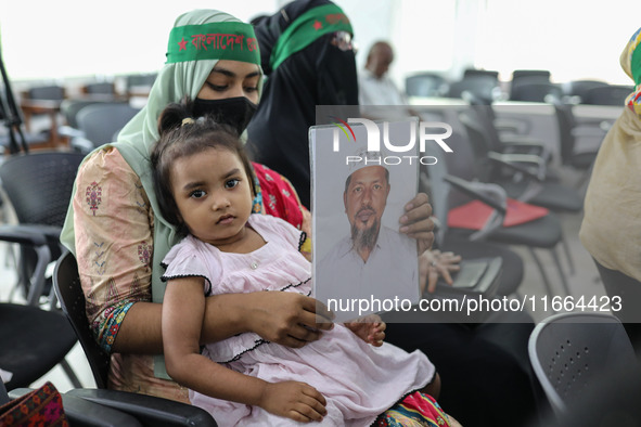 Family members of the victims of enforced disappearance hold portraits of their disappeared relatives during a press conference at the Natio...