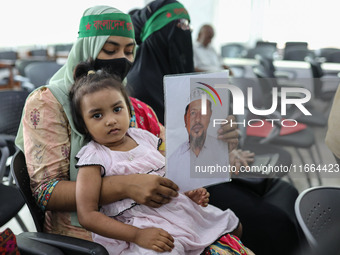 Family members of the victims of enforced disappearance hold portraits of their disappeared relatives during a press conference at the Natio...