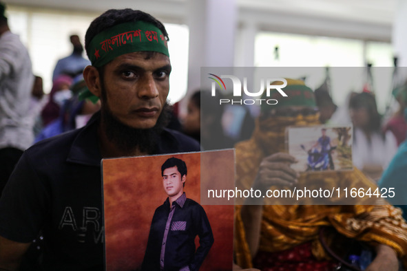 Family members of the victims of enforced disappearance hold portraits of their disappeared relatives during a press conference at the Natio...