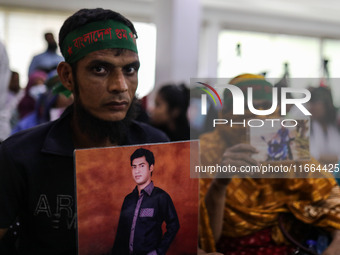 Family members of the victims of enforced disappearance hold portraits of their disappeared relatives during a press conference at the Natio...