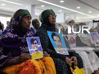 Family members of the victims of enforced disappearance hold portraits of their disappeared relatives during a press conference at the Natio...