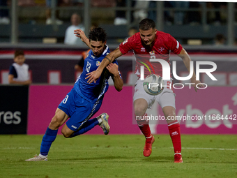 Maxim Cojocaru of Moldova challenges for the ball with Jean Borg of Malta during the UEFA Nations League, League D, Group D2 soccer match be...