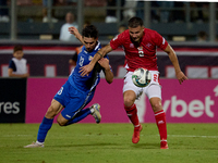 Maxim Cojocaru of Moldova challenges for the ball with Jean Borg of Malta during the UEFA Nations League, League D, Group D2 soccer match be...