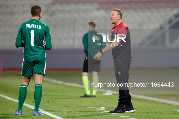 In Ta' Qali, Malta, on October 13, 2024, Davide Mazzotta, interim coach of Malta, speaks with Henry Bonello, goalkeeper of Malta, during the...