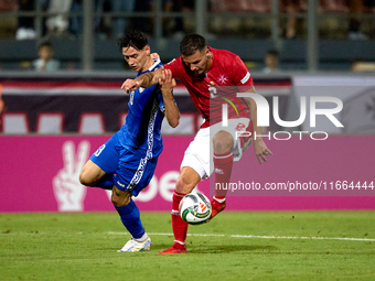 Maxim Cojocaru of Moldova challenges for the ball with Jean Borg of Malta during the UEFA Nations League, League D, Group D2 soccer match be...