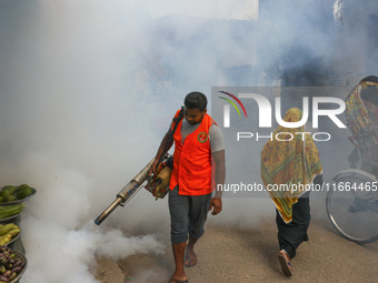 A city corporation worker sprays fumigator to control mosquitoes as the number of dengue-infected patients increases in Dhaka, Bangladesh, o...