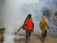 A city corporation worker sprays fumigator to control mosquitoes as the number of dengue-infected patients increases in Dhaka, Bangladesh, o...