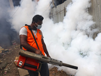 A city corporation worker sprays fumigator to control mosquitoes as the number of dengue-infected patients increases in Dhaka, Bangladesh, o...