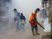 A city corporation worker sprays fumigator to control mosquitoes as the number of dengue-infected patients increases in Dhaka, Bangladesh, o...