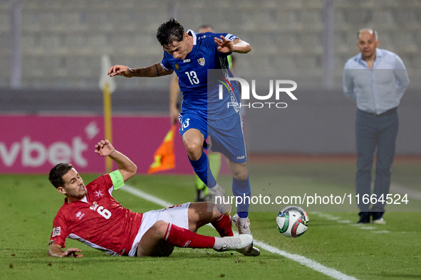 In Ta' Qali, Malta, on October 13, 2024, Maxim Cojocaru of Moldova is closely challenged by Matthew Guillaumier of Malta during the UEFA Nat...