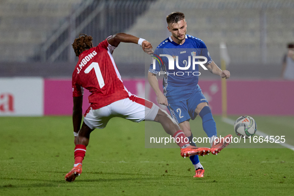 Oleg Reabciuk of Moldova is challenged by Joseph Mbong of Malta during the UEFA Nations League, League D, Group D2 soccer match between Malt...