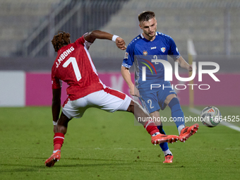 Oleg Reabciuk of Moldova is challenged by Joseph Mbong of Malta during the UEFA Nations League, League D, Group D2 soccer match between Malt...