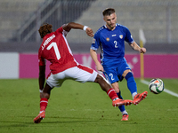 Oleg Reabciuk of Moldova is challenged by Joseph Mbong of Malta during the UEFA Nations League, League D, Group D2 soccer match between Malt...