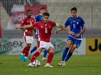 Matthew Guillaumier of Malta is closely followed by Mihail Caimacov of Moldova during the UEFA Nations League, League D, Group D2 soccer mat...