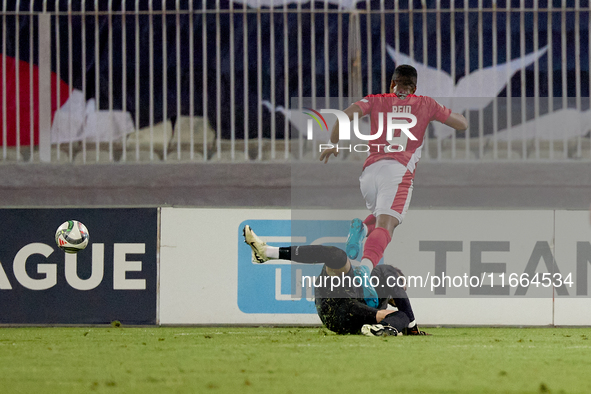 In Ta' Qali, Malta, on October 13, 2024, Kemar Reid of Malta is fouled by the onrushing Moldova goalkeeper Dumitru Celeadnic for an eventual...