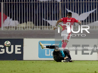 In Ta' Qali, Malta, on October 13, 2024, Kemar Reid of Malta is fouled by the onrushing Moldova goalkeeper Dumitru Celeadnic for an eventual...