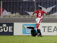 In Ta' Qali, Malta, on October 13, 2024, Kemar Reid of Malta is fouled by the onrushing Moldova goalkeeper Dumitru Celeadnic for an eventual...