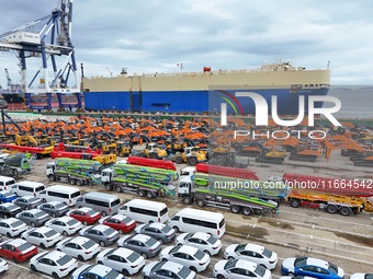 Chinese domestically made cars and construction machinery gather for shipment for export at Yantai Port in Shandong province, China, on Octo...