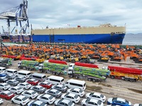 Chinese domestically made cars and construction machinery gather for shipment for export at Yantai Port in Shandong province, China, on Octo...