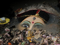 An idol of Goddess Durga is seen in the waters of the Kuakhai River as devotees immerse it, marking the conclusion of the 10-day Durga Puja...