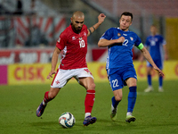 In Ta' Qali, Malta, on October 13, 2024, Teddy Teuma of Malta is closely followed by Vadim Rata of Moldova during the UEFA Nations League, L...