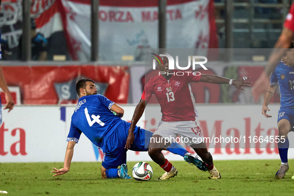 In Ta' Qali, Malta, on October 13, 2024, Basil Tuma of Malta is challenged by Vladislav Babogio of Moldova during the UEFA Nations League, L...