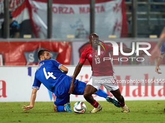 In Ta' Qali, Malta, on October 13, 2024, Basil Tuma of Malta is challenged by Vladislav Babogio of Moldova during the UEFA Nations League, L...