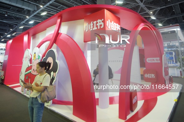 Visitors visit the stand of Little Red Book at an exhibition in Hangzhou, Zhejiang province, China, on September 25, 2024. 