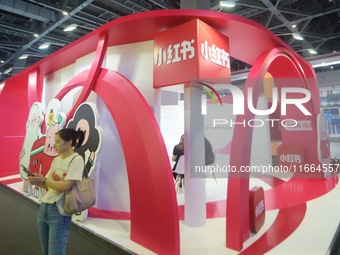 Visitors visit the stand of Little Red Book at an exhibition in Hangzhou, Zhejiang province, China, on September 25, 2024. (