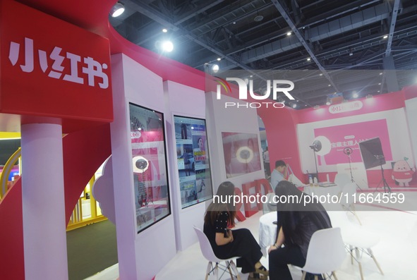 Visitors visit the stand of Little Red Book at an exhibition in Hangzhou, Zhejiang province, China, on September 25, 2024. 