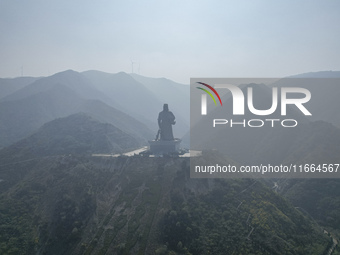 The statue of Guan Gong, the world's tallest saint, is seen under mist in Yuncheng, China, on October 14, 2024. (