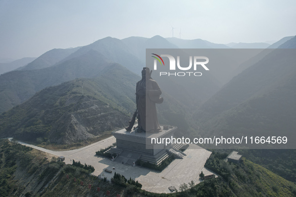 The statue of Guan Gong, the world's tallest saint, is seen under mist in Yuncheng, China, on October 14, 2024. 